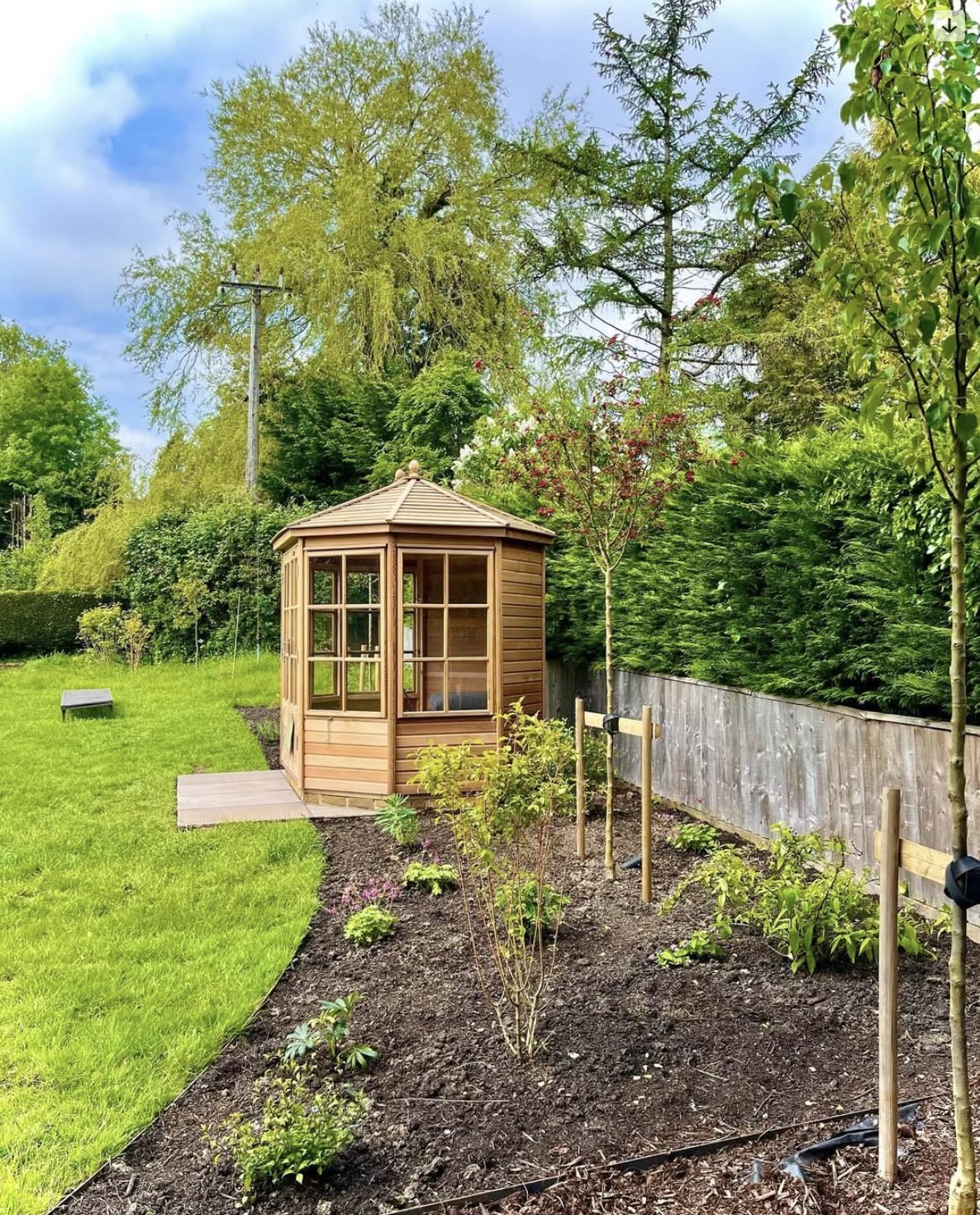 Planting beds and summerhouse in a landscaped Hertfordshire garden